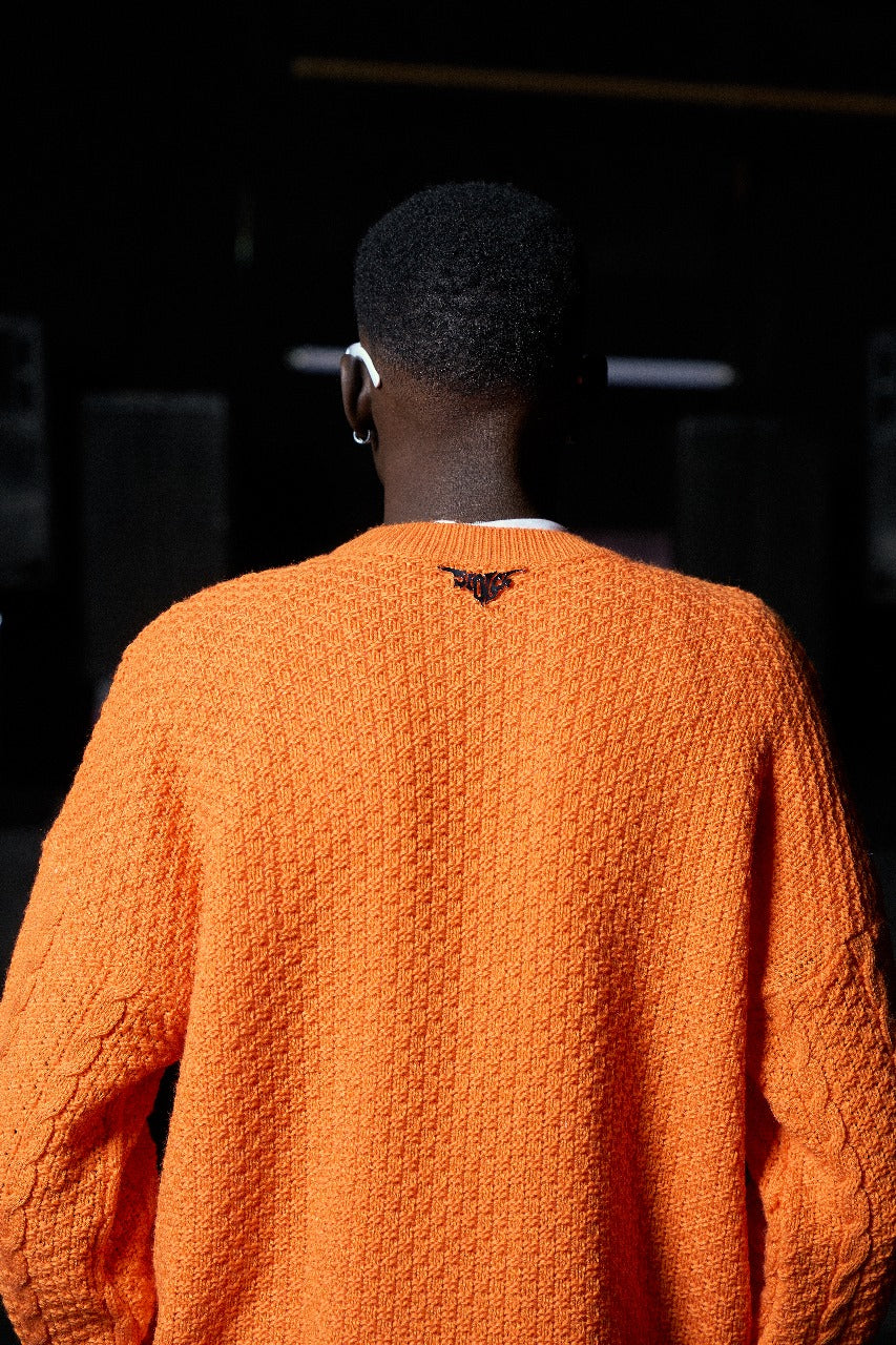 Orange braided sweater